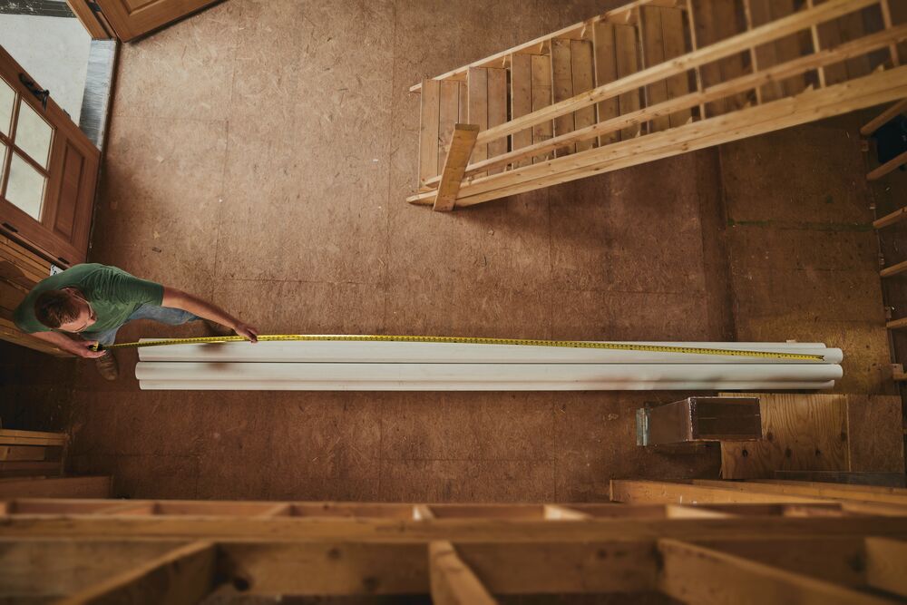 25 foot FATMAX classic tape measure being used by a person to measure pipe length.