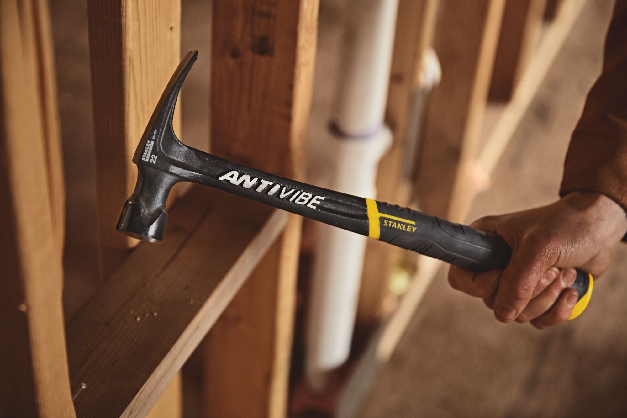 22 ounce fat max anti vibe framing hammer being used.