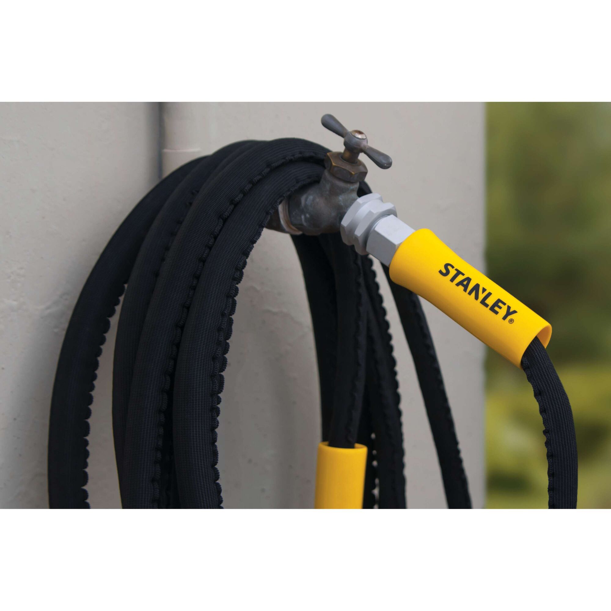 50 foot Dura flexpro expanding garden hose connected to outdoor faucet.