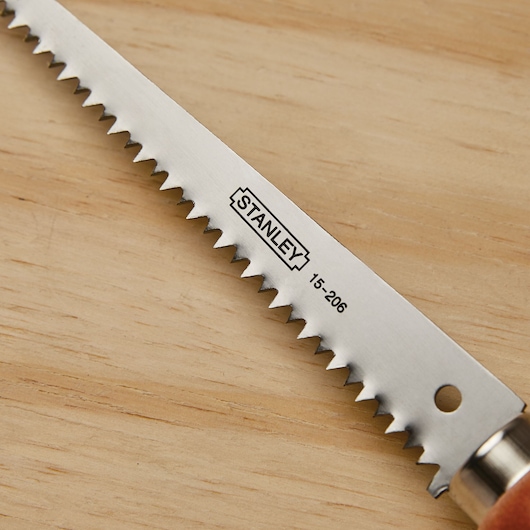 Sharp tooth blade feature of a 6 inch wood handle wallboard saw.