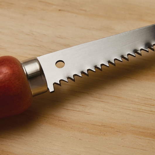 Sturdy blade feature of a 6 inch wood handle wallboard saw.