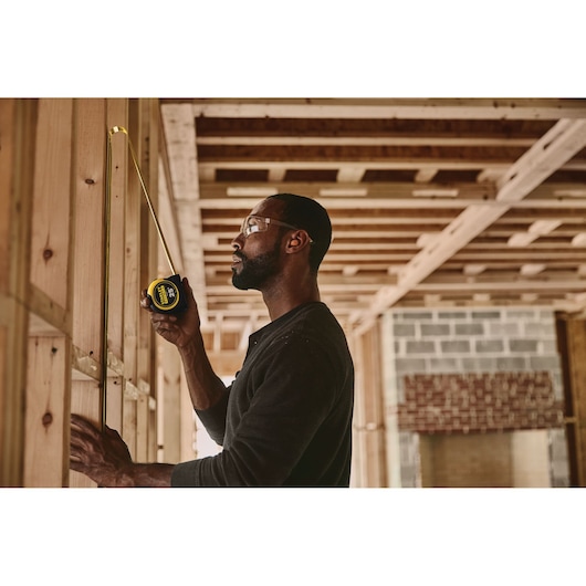 25 foot FATMAX classic tape measure being used by a person.