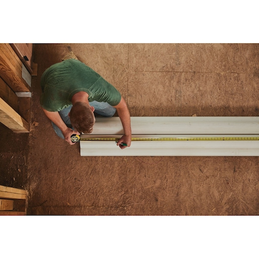 25 foot FATMAX classic tape measure being used by a person to measure length.