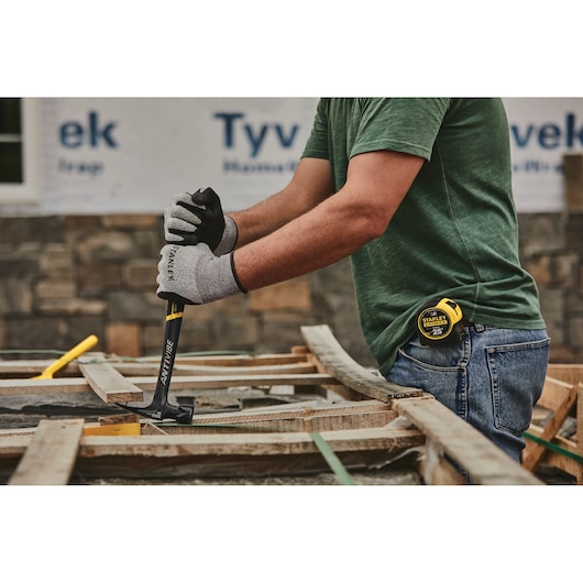 22 ounces rip claw framing hammer being used to pull out nails.