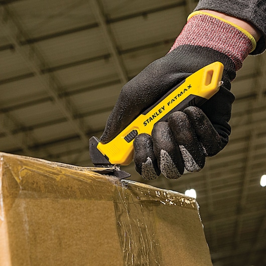 Fatmax single sided replaceable head pull cutter being used to cut a box.