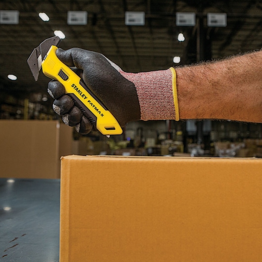 Fatmax single sided replaceable head pull cutter being used to cut a box.