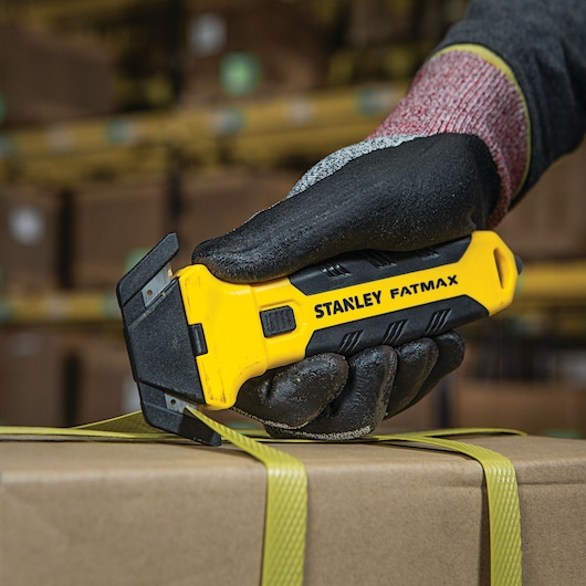 Fatmax double sided replaceable head pull cutter being used to cut straps.