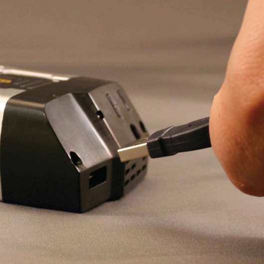 120 watt power inverter with AC and USB chargers being plugged in by a person.