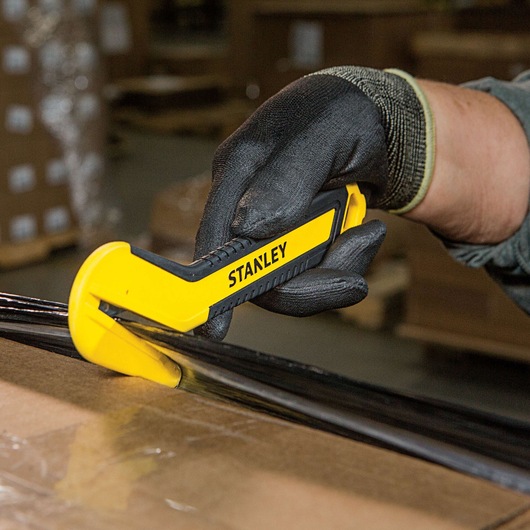 SINGLE SIDED ROUND TIP BI MATERIAL PULL CUTTER BEING USED FOR CUTTING PLASTIC WRAPPING FROM ROUNDED SIDE.