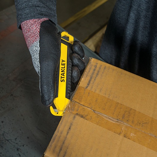 DOUBLE SIDED BI MATERIAL PULL CUTTER being used for opening package.