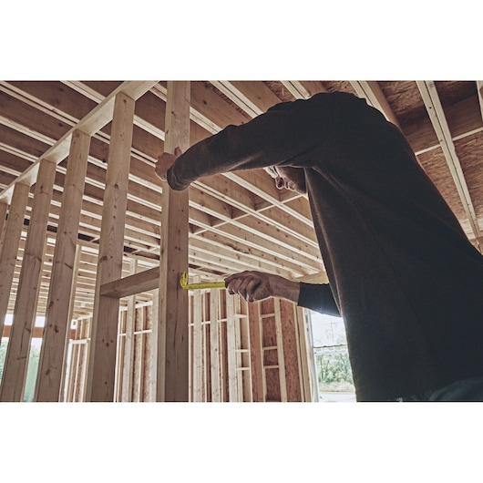 10 inch Gripped Nail Puller being used by person to pull nail out of wood.