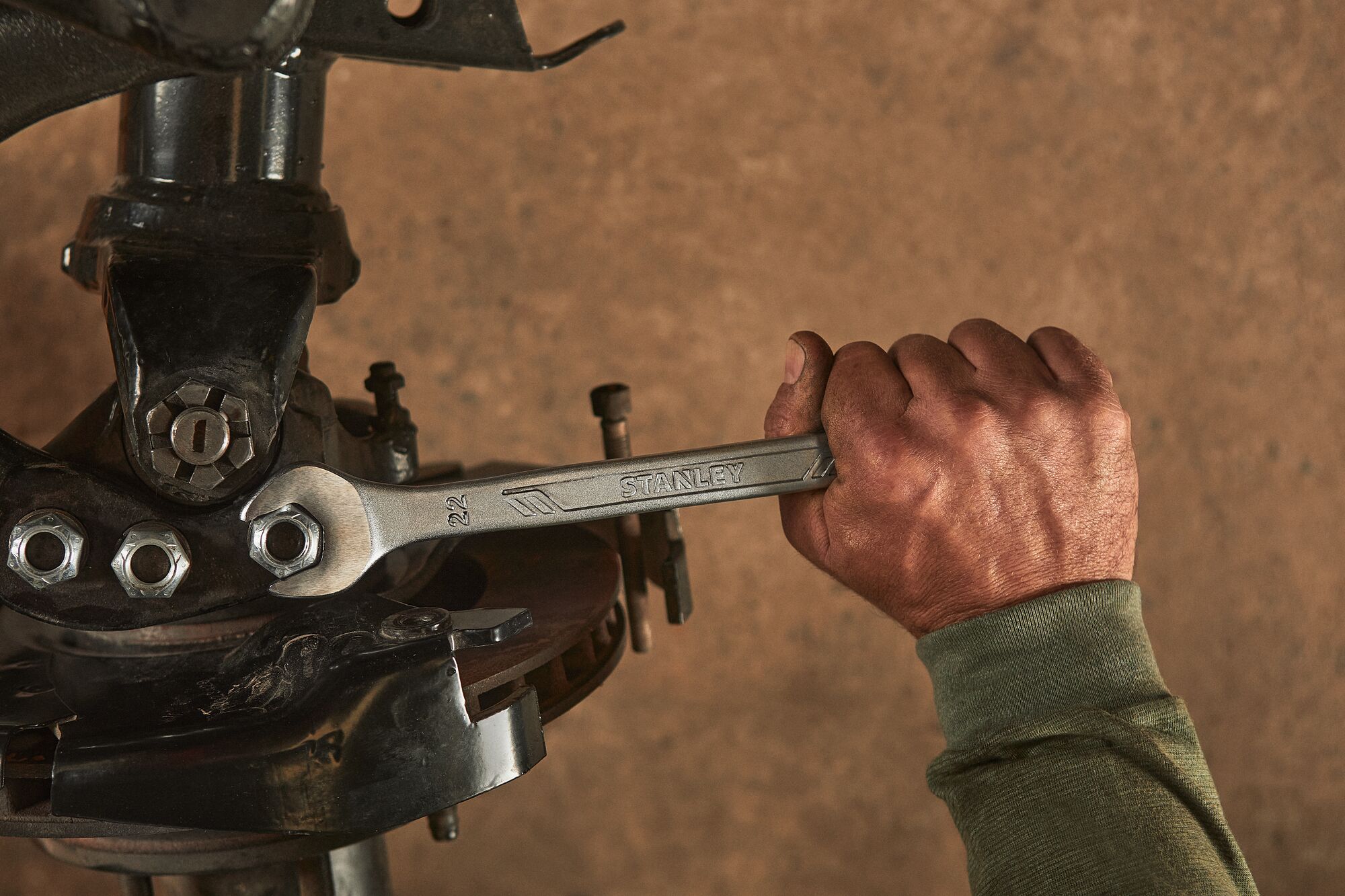 Close up of mechanic using a STANLEY Antislip Wrench on a car's engine